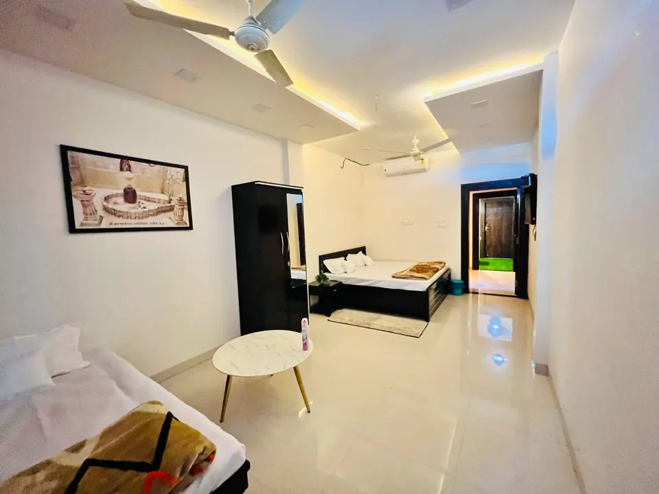Suite living area with a sofa and bed at AP Suite, AP Villas Ujjain