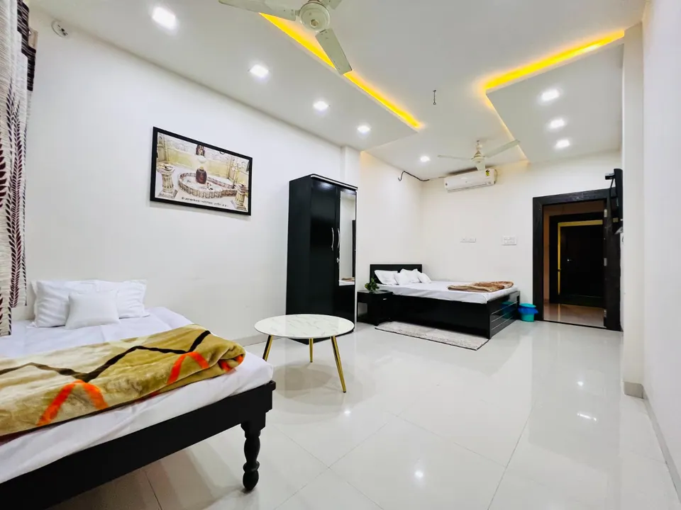 Spacious bedroom with seating at AP Suite, AP Villas Ujjain