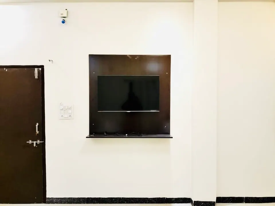 TV wall in the lounge at Divinestay, AP Villas Ujjain