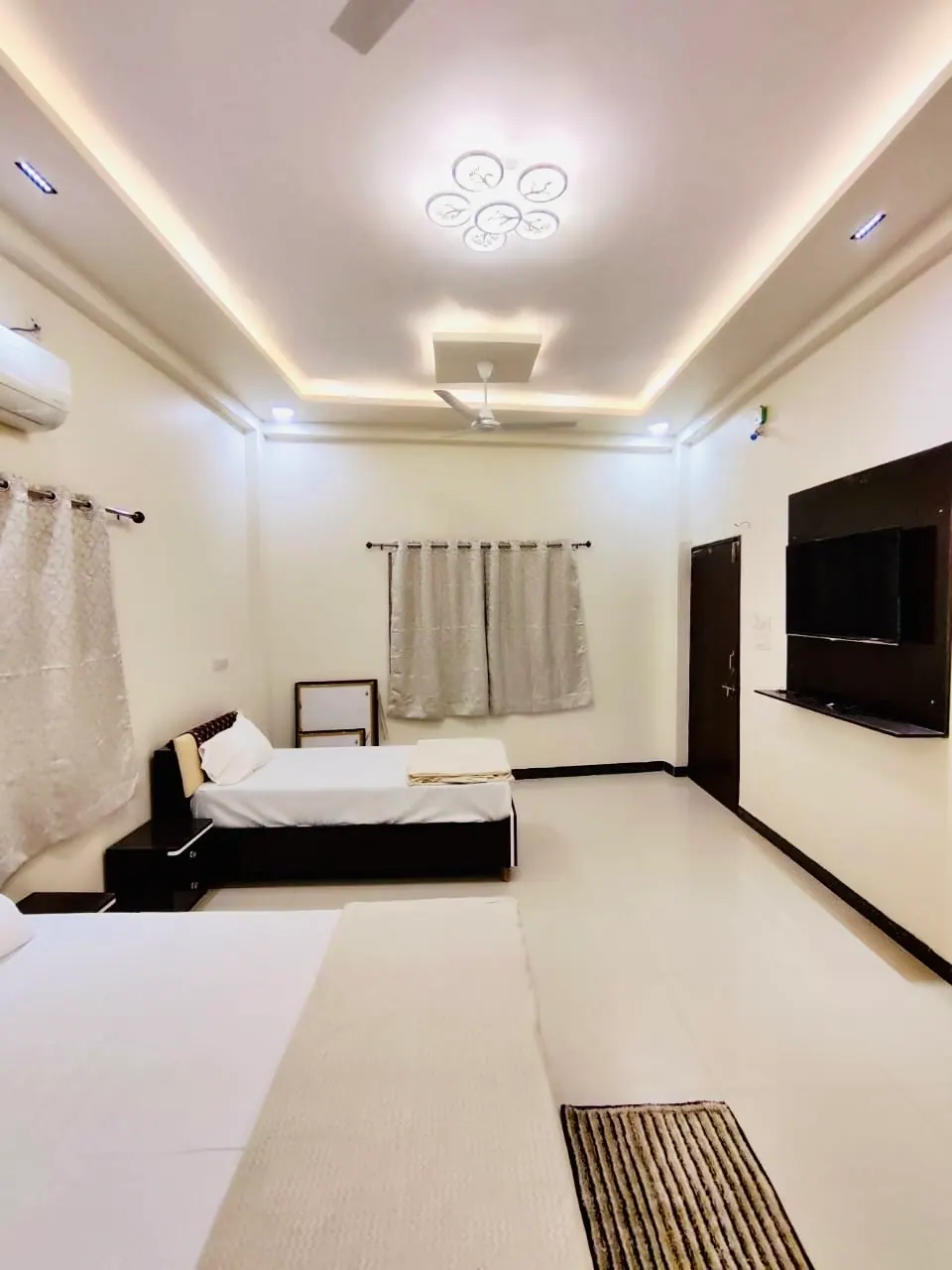 Bedroom with double bed and ceiling lights at Divinestay, AP Villas Ujjain