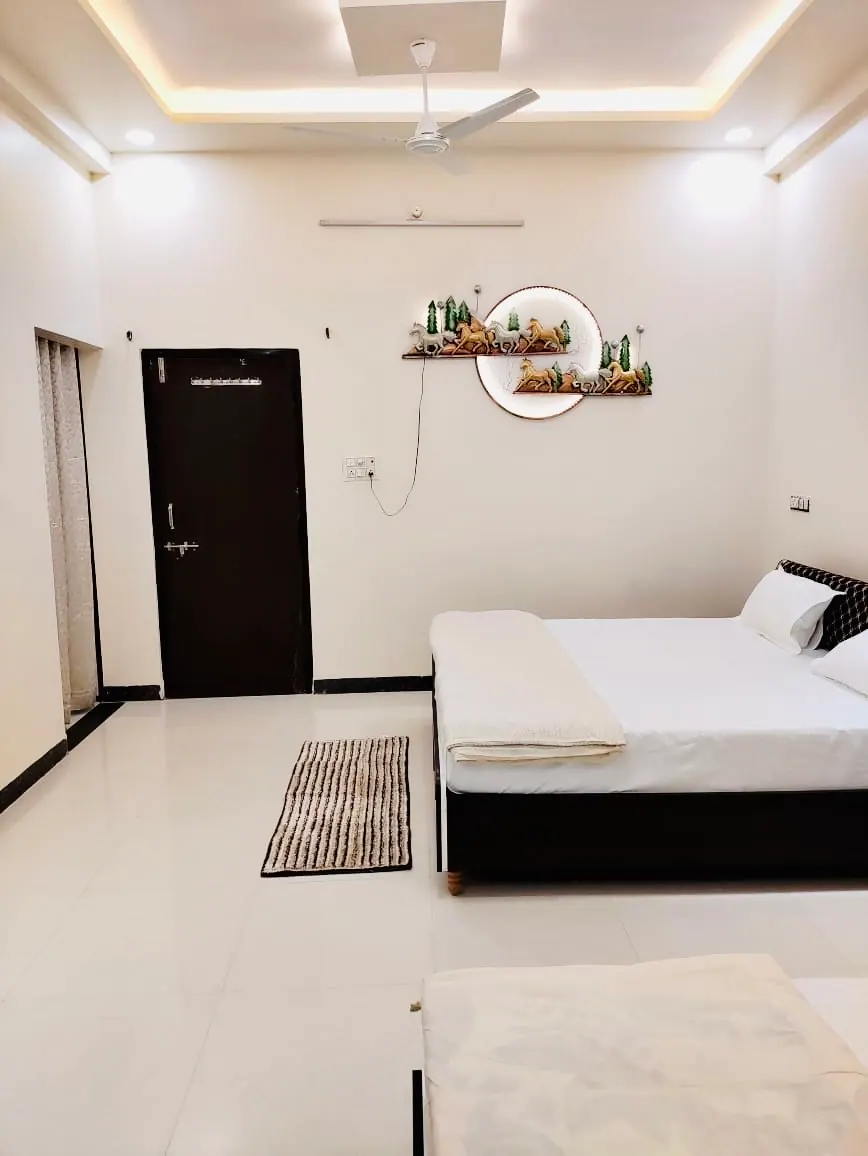 Bedroom with double bed and wall shelf at Divinestay, AP Villas Ujjain