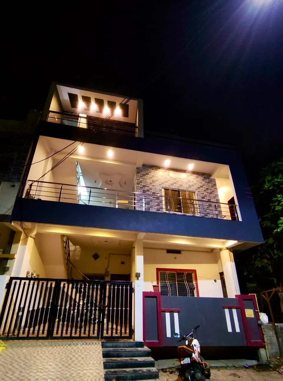 Villa facade lit at night at Divinestay, AP Villas Ujjain