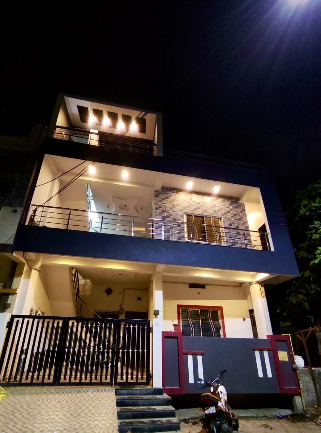 Villa facade lit at night at Divinestay, AP Villas Ujjain