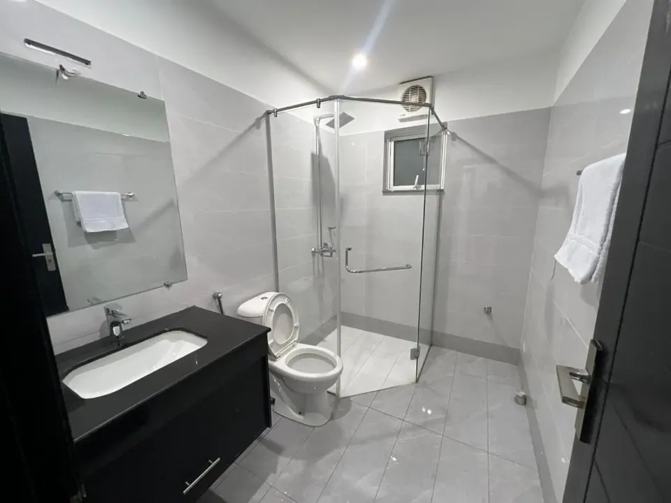 Bathroom with glass shower at Om Shanti Stay, AP Villas Ujjain