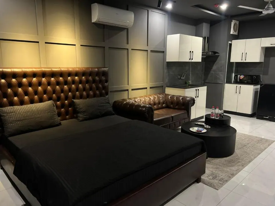 Living area with sofa and bed at Om Shanti Stay, AP Villas Ujjain