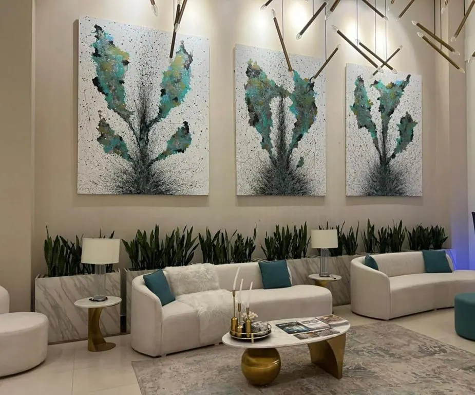 Lounge with sofas and cactus wall art at Om Shanti Stay, AP Villas Ujjain