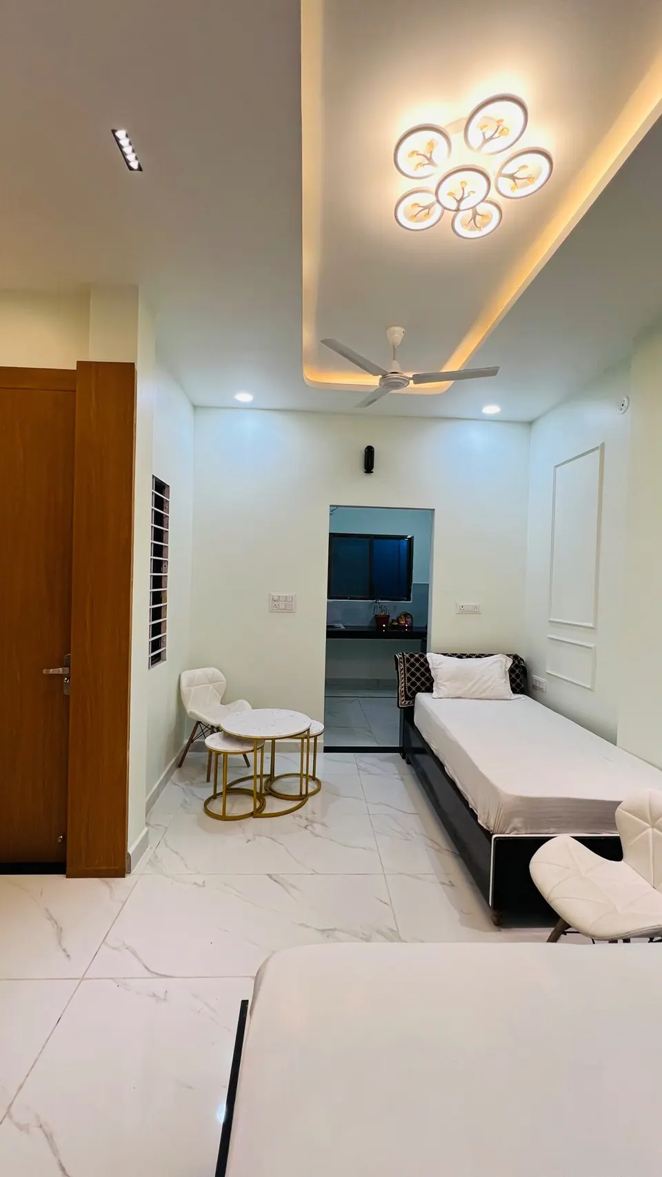 Room with bed and armchair at Rudrangan Suites, AP Villas Ujjain