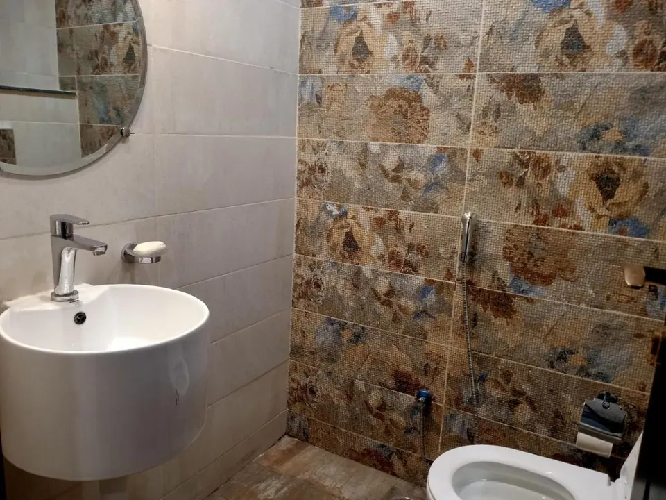 Bathroom washbasin with stone wall at Villa Aranya, AP Villas Ujjain